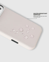 Water beading on the splash-resistant surface of the white STICKYZOO leather phone case