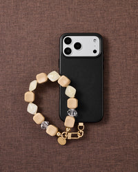 Latte marbled bead phone strap styled on fabric, loved by thousands of STICKYZOO customers