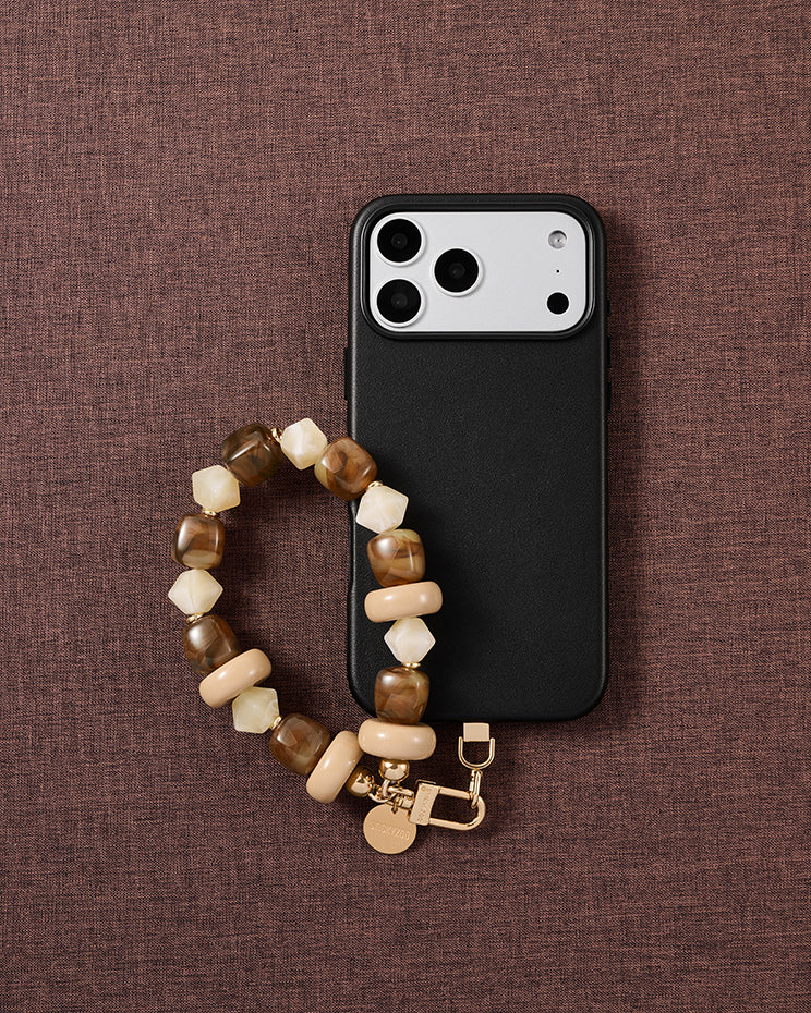 Toffee marbled bead phone strap styled on fabric, loved by thousands of STICKYZOO customers