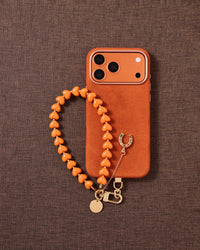 {Designed in Amsterdam} Tangerine heart beads and gold horseshoe charm phone strap styled flat-lay by STICKYZOO