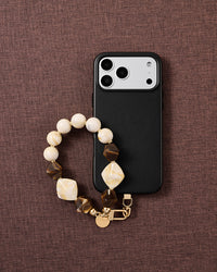 Mocha marbled bead phone strap styled on fabric, loved by thousands of STICKYZOO customers