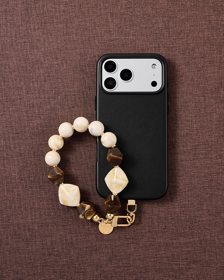 Mocha marbled bead phone strap styled on fabric, loved by thousands of STICKYZOO customers