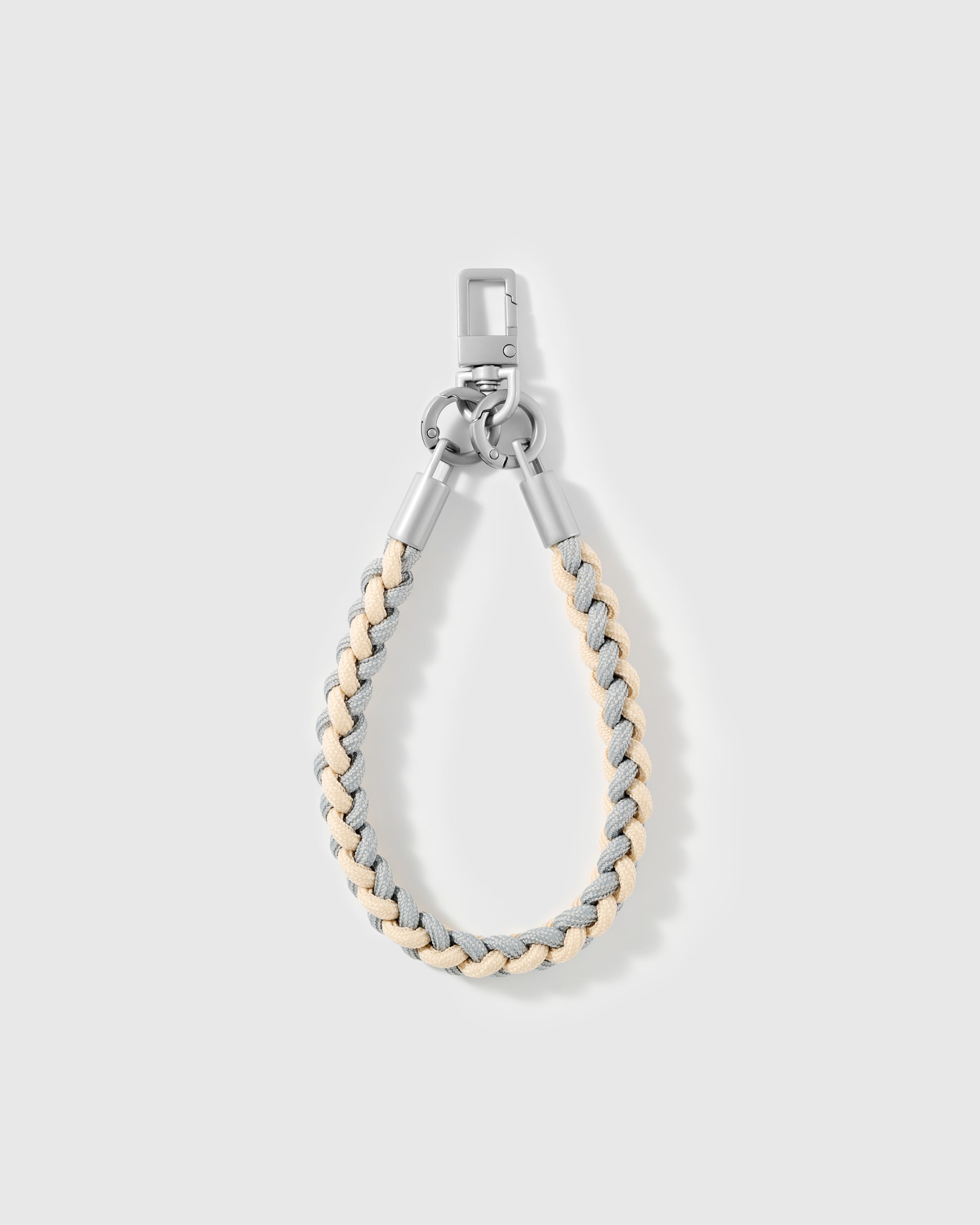 Detail of the grey and cream braided accent on the cross-body phone strap
