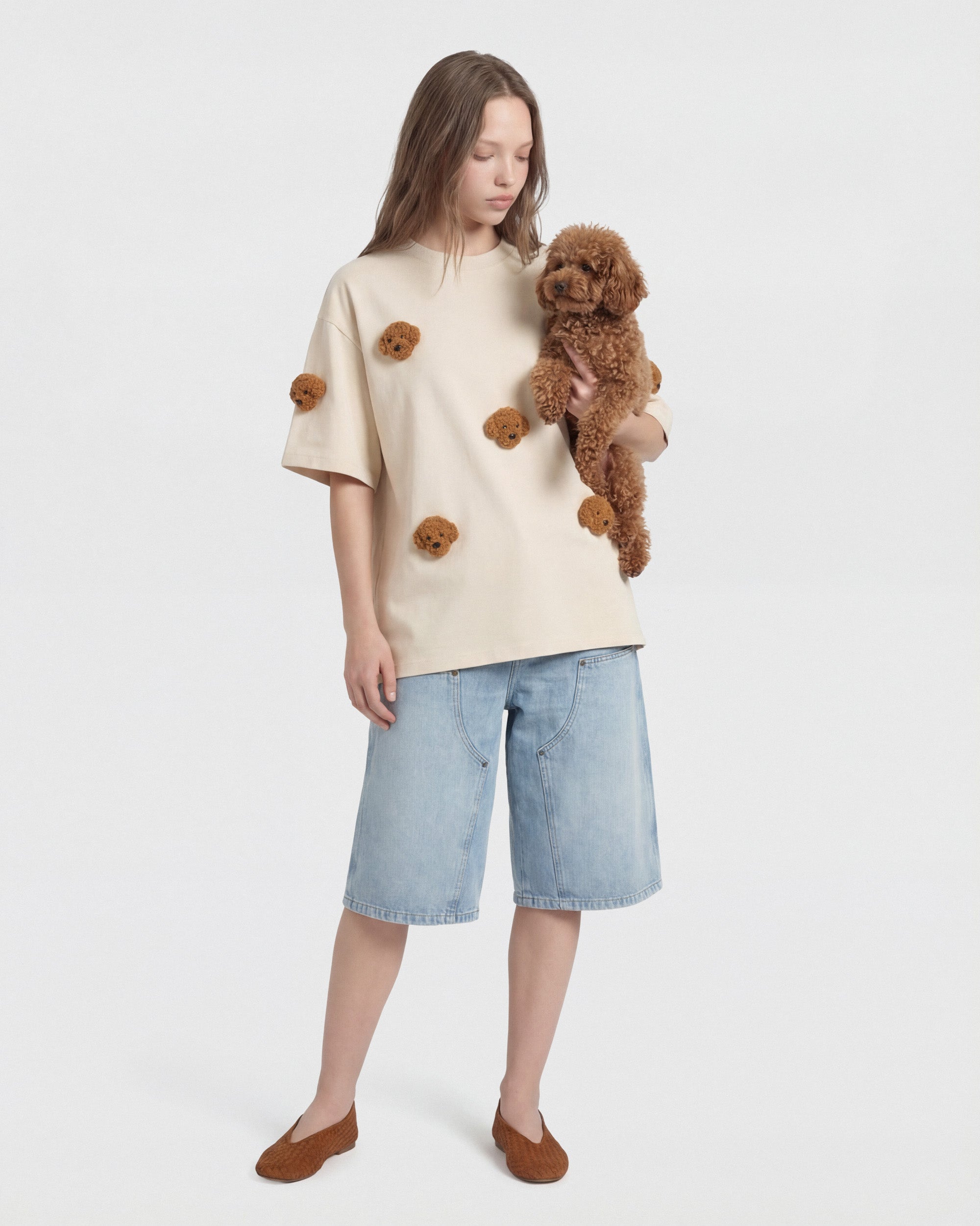 {{Model is wearing size M}} Model wearing cream STICKYZOO Poodle Parade T-Shirt holding a real poodle showing plush appliques
