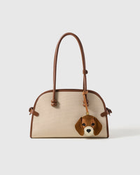 beagle charm styled on bag — French Alran goatskin leather, alcantara suede ears that drape naturally. 72 hours of handcraft per piece.