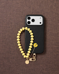 STICKYZOO lemon daisy heart phone strap on warm flat-lay — Designed in Amsterdam