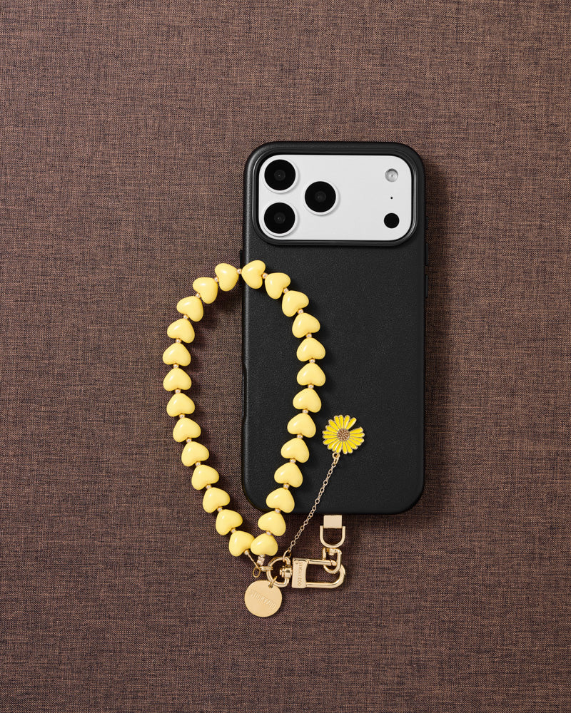 STICKYZOO lemon daisy heart phone strap on warm flat-lay — Designed in Amsterdam