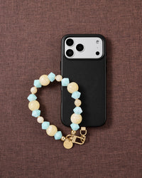 Aqua marbled bead phone strap styled on fabric, loved by thousands of STICKYZOO customers
