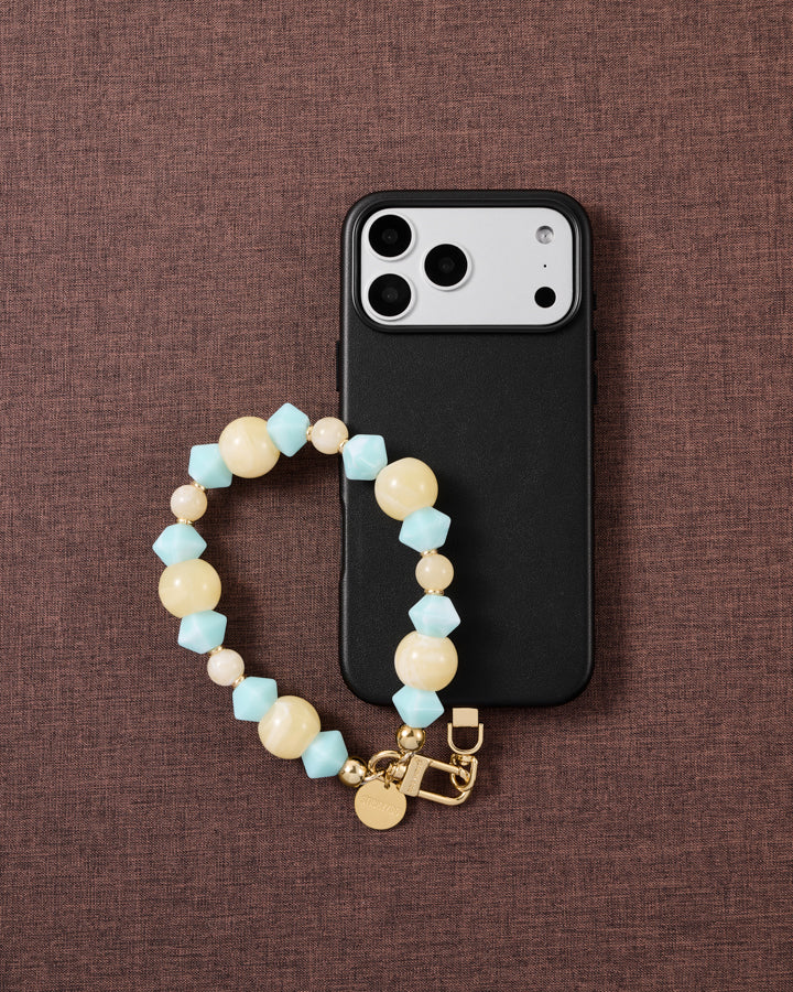 Aqua marbled bead phone strap styled on fabric, loved by thousands of STICKYZOO customers
