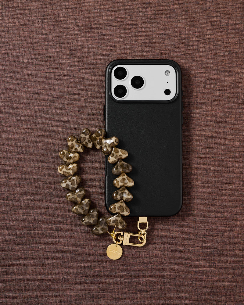 The only patterned strap in the collection smoke leopard heart phone strap styled flat-lay, designed in Amsterdam