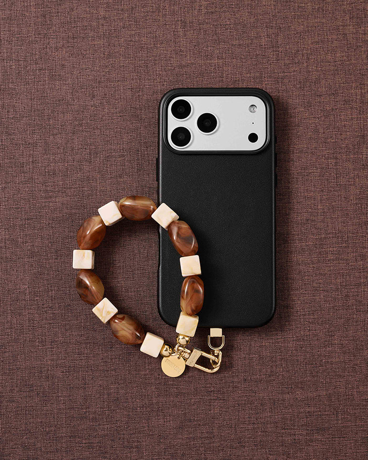 Cognac marbled bead phone strap styled on fabric, loved by thousands of STICKYZOO customers