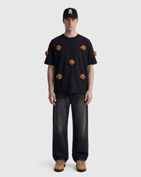 Model in black Poodle Parade T-Shirt front view showing all seven plush poodle appliques