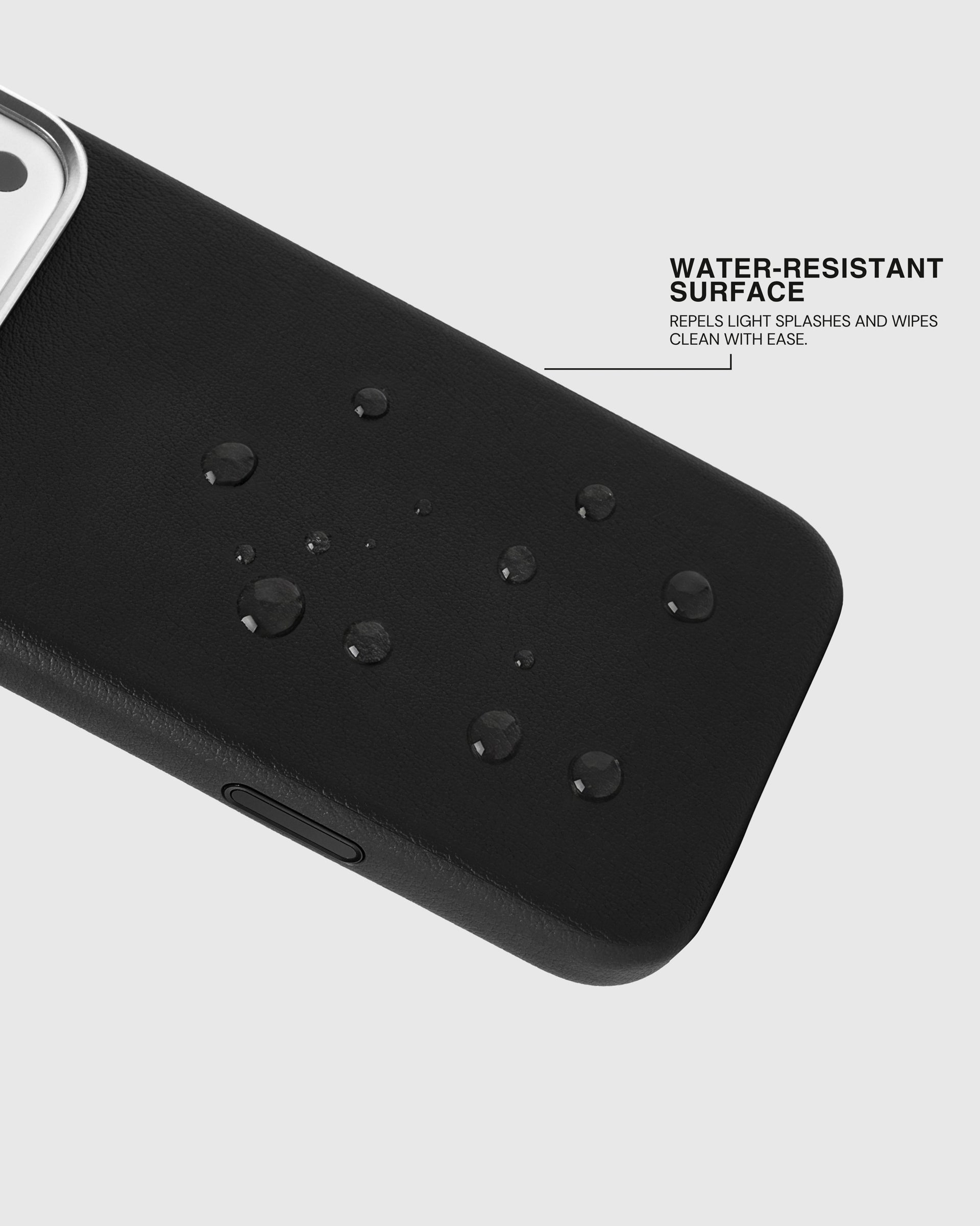 Water beading on the splash-resistant surface of the black STICKYZOO leather phone case