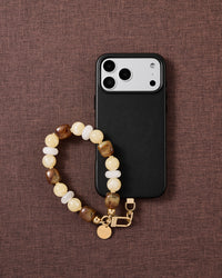 Honey marbled bead phone strap styled on fabric, loved by thousands of STICKYZOO customers