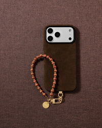 Handmade copper goldstone wrist strap styled in a lifestyle flat-lay on soft fabric