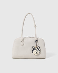 STICKYZOO husky charm attached to off-white structured handbag showing bag charm styling