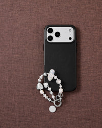 Pearl and silver beaded phone strap on brown fabric: iridescent cloud bead, silver stars, faceted clear gem, foil heart and STICKYZOO disc