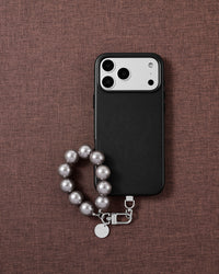 Grey pearl phone strap styled on fabric, loved by thousands of STICKYZOO customers
