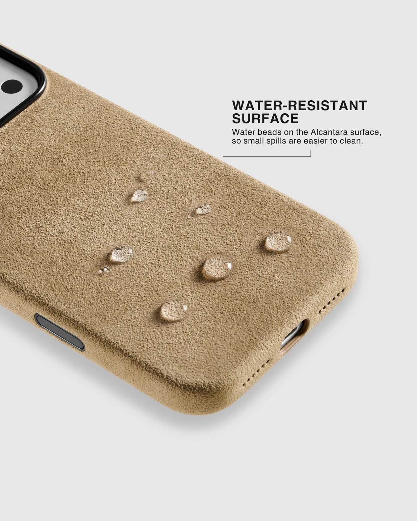 Water droplets beading on the surface of a camel Alcantara suede phone case showing water-resistant finish
