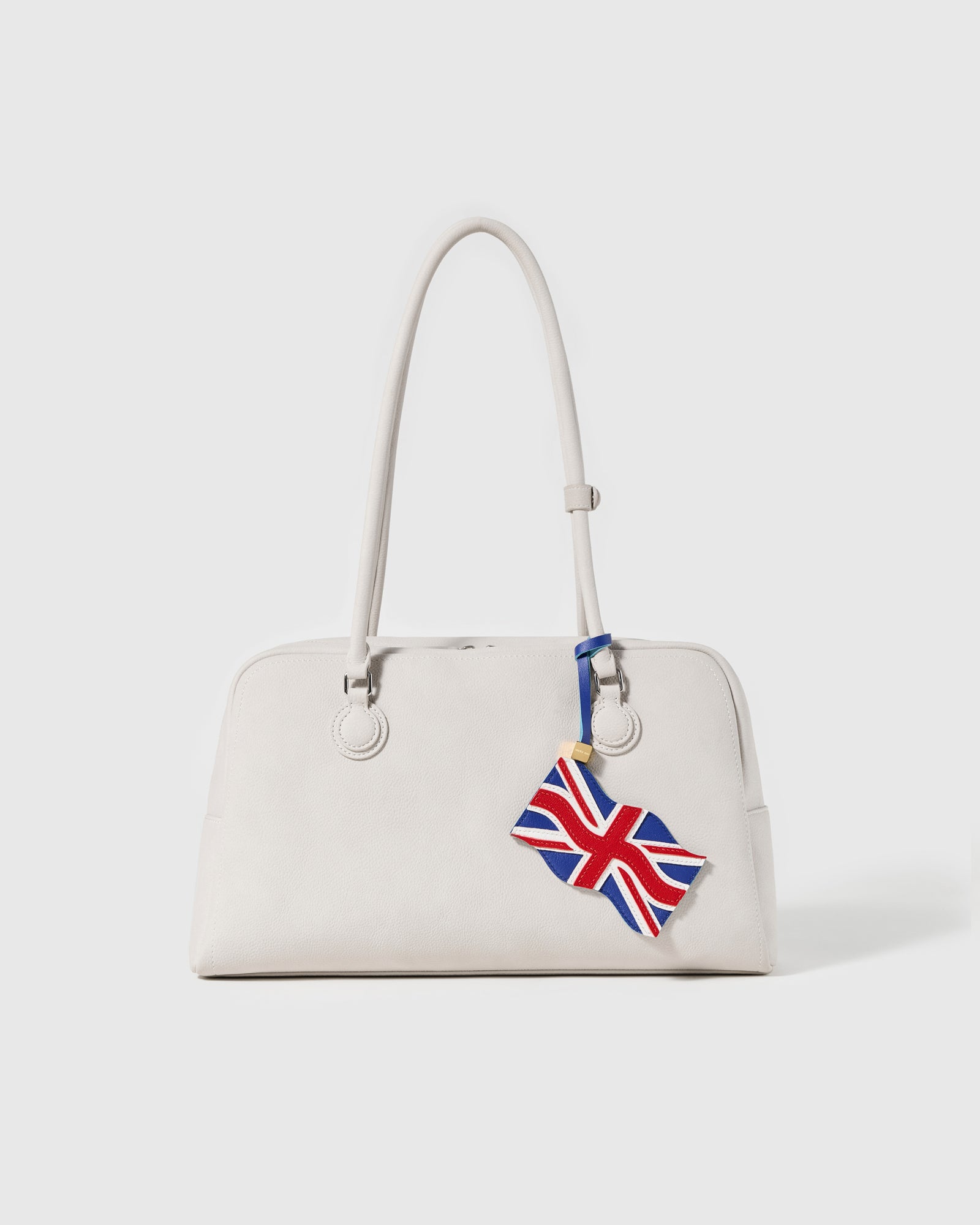 Close-up of Union Jack charm showing individual hand-cut leather panels forming the crossed flag pattern