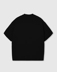 Back view of an oversized black STICKYZOO T-Shirt showing the clean blank back panel and relaxed boxy proportions.