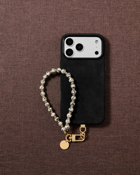 Cream speckled stone bead phone strap styled on fabric, loved by thousands of STICKYZOO customers
