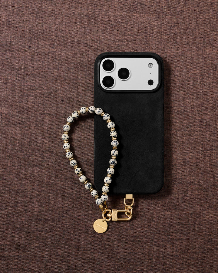 Cream speckled stone bead phone strap styled on fabric, loved by thousands of STICKYZOO customers