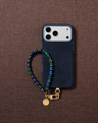 Blue-and-green stone bead phone strap styled on fabric, loved by thousands of STICKYZOO customers