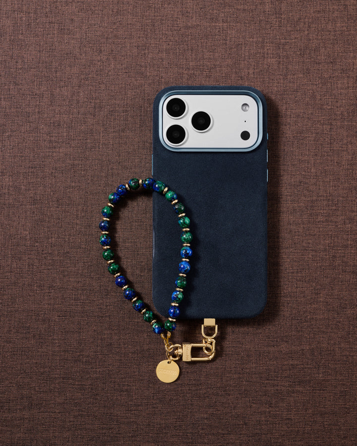 Blue-and-green stone bead phone strap styled on fabric, loved by thousands of STICKYZOO customers