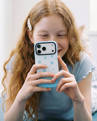 Hand holding the sky-star phone case with fingers wrapped around the back to steady a shot