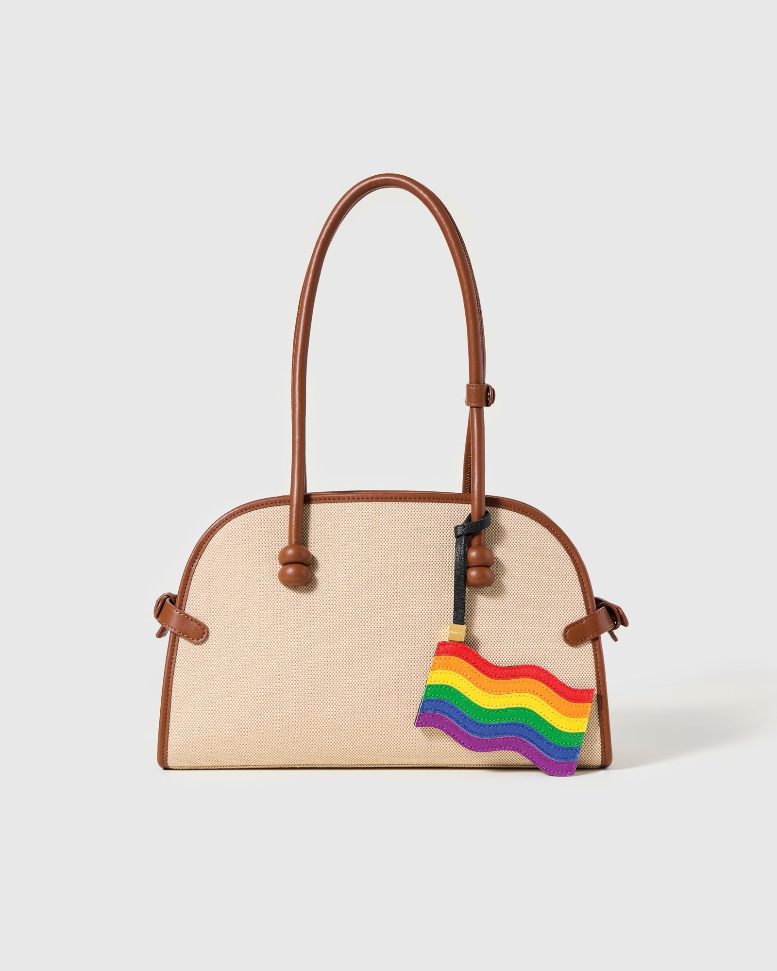 Pride flag leather charm on canvas and tan bag — handmade rainbow waving flag by STICKYZOO