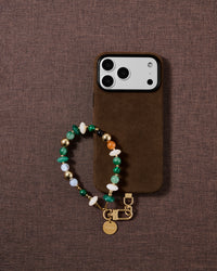 Emerald green mixed bead phone strap styled on fabric, loved by thousands of STICKYZOO customers