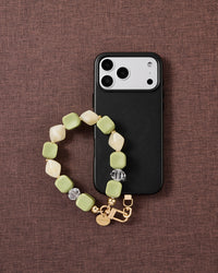 Matcha marbled bead phone strap styled on fabric, loved by thousands of STICKYZOO customers
