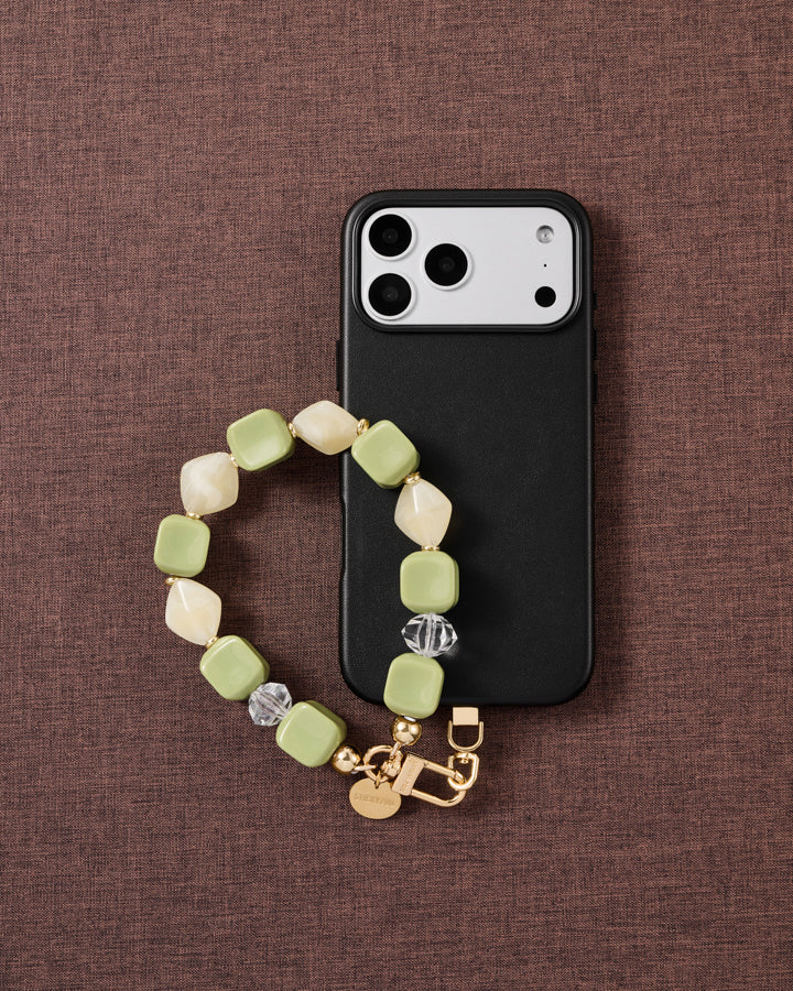 Matcha marbled bead phone strap styled on fabric, loved by thousands of STICKYZOO customers