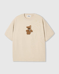 Front flat-lay of STICKYZOO Hug-Me Bear T-Shirt in cream with plush bear