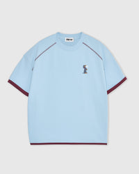 Front view showing embroidered standing dachshund on sky blue cotton with burgundy ringer trim at sleeves