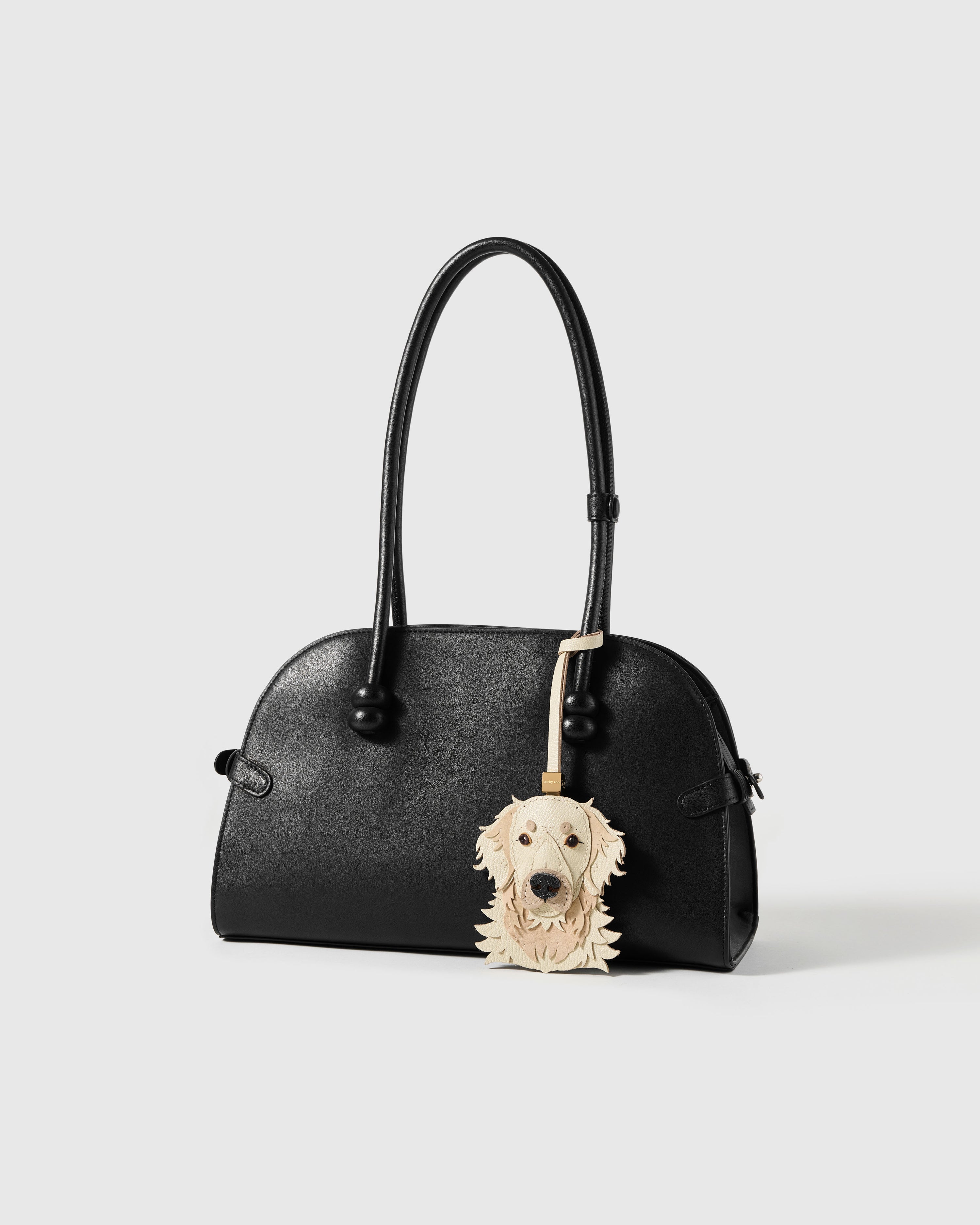{{Rated 4.9★.}} Golden Retriever charm on a bag, styled — rated 4.9★ by thousands of buyers. French Alran leather + alcantara suede, 72 hours by hand.