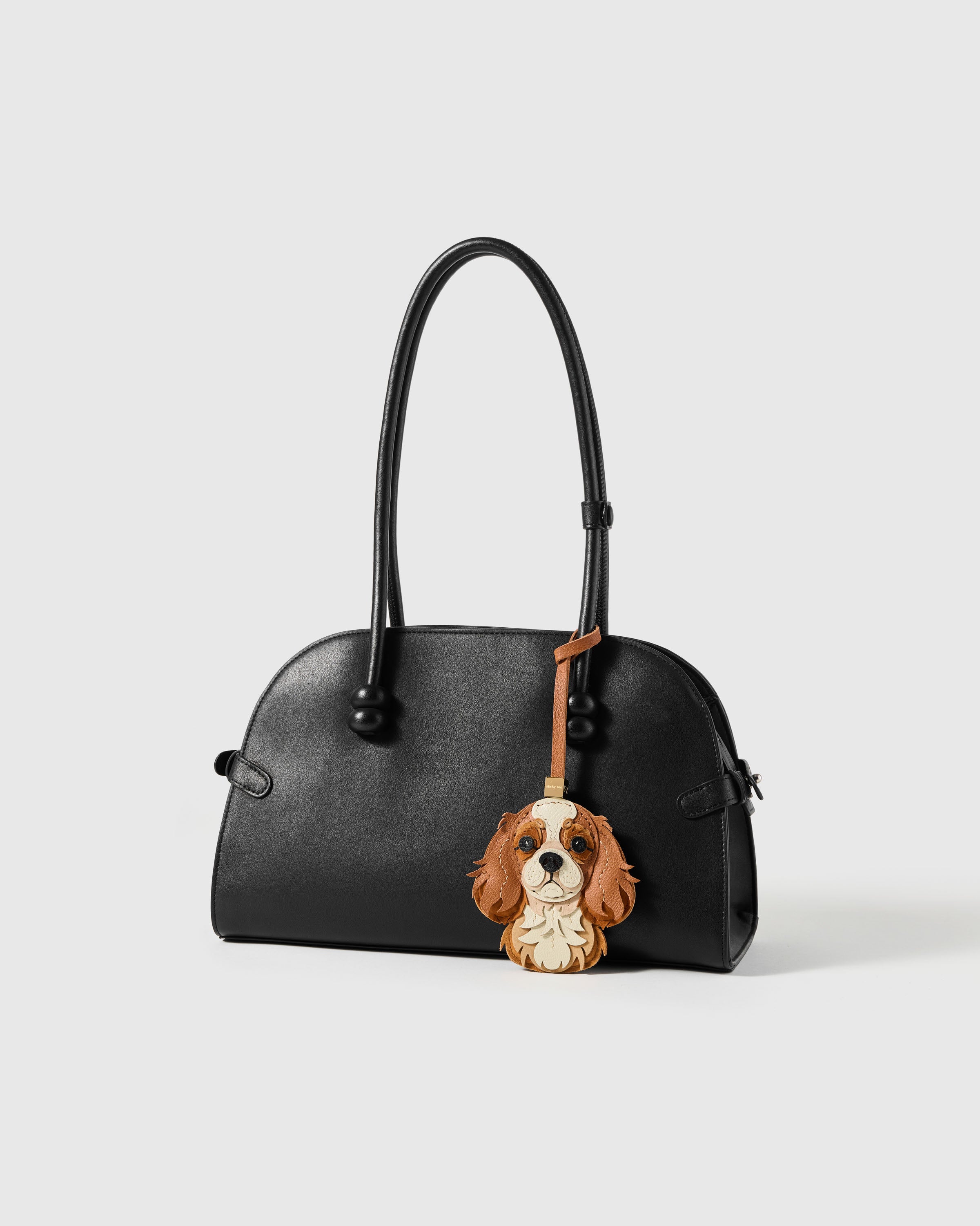 {{100,000+ sold.}} Handmade Cavalier King Charles charm in French Alran leather on black handbag — the breed charm people come back for.