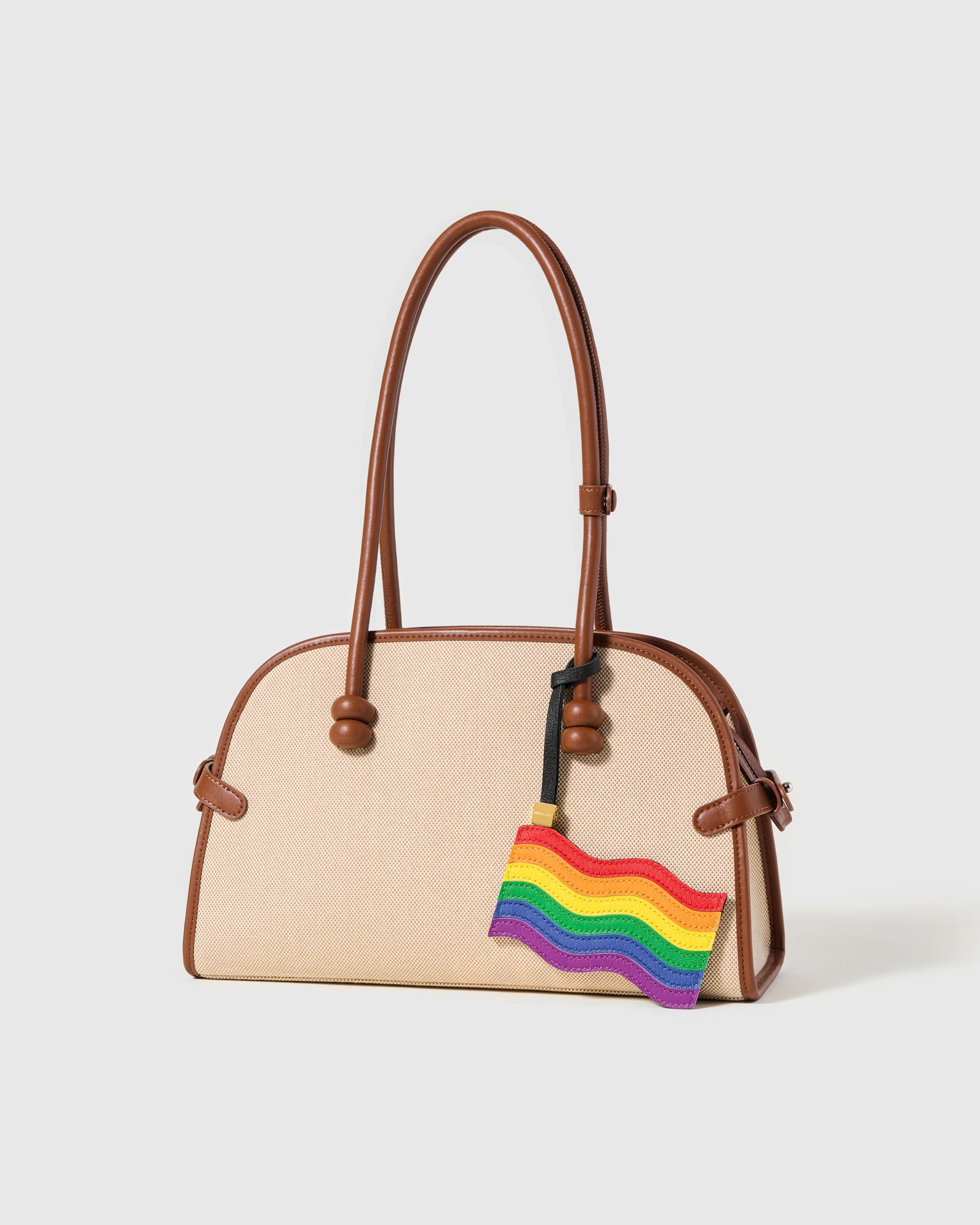 Handmade pride flag charm on canvas bag — six hand-stitched rainbow leather layers by STICKYZOO