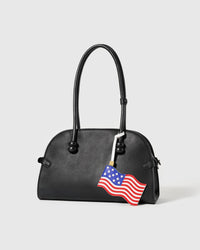 Handmade American flag leather charm on cream bag — waving Stars and Stripes by STICKYZOO