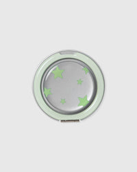 Close-up of the round acrylic-resin pop-grip medallion with a mirrored centre and the matching green star print.
