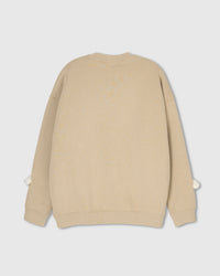 Back view of beige Teddy Check-Ear Sweatshirt showing clean silhouette with bear faces peeking at cuffs