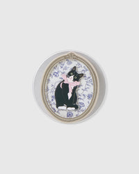 Close-up of the 3D tuxedo cat in a vintage oval frame embedded inside the acrylic-resin grip medallion
