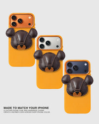 Three Bear Charm Cases on gold, silver, and dark blue iPhone models — same handmade French Alran leather bear, made to match every iPhone color. Loved by Thousands.