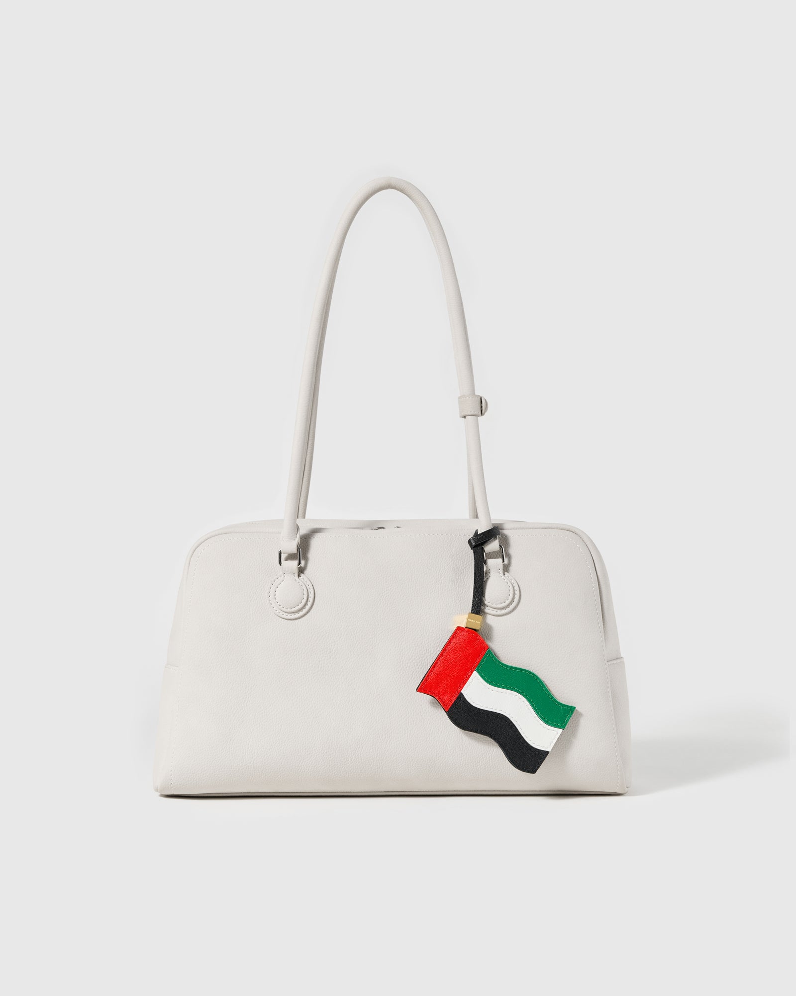 STICKYZOO UAE flag charm draped on cream leather bag in studio lighting