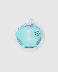 Close-up of the 3D teal seashell with stars and crystal studs embedded inside the acrylic-resin grip top