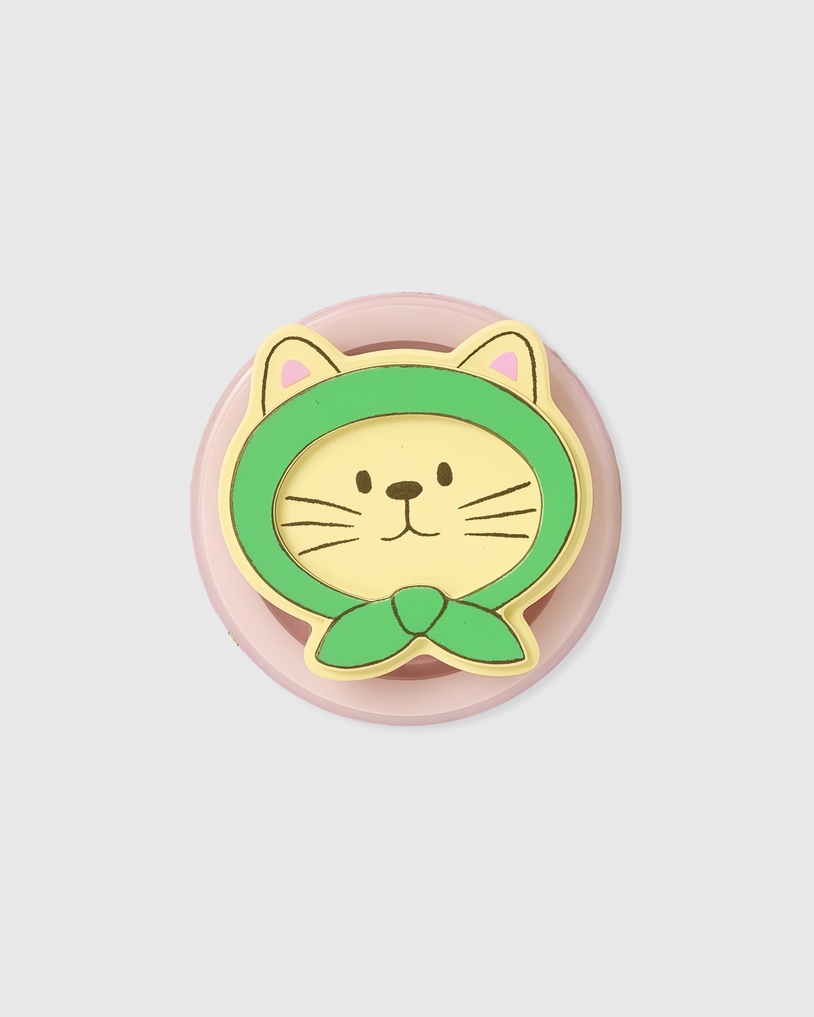 Close-up of the 3D green-hood cat face set into the acrylic-resin grip top on a pink rotating base.