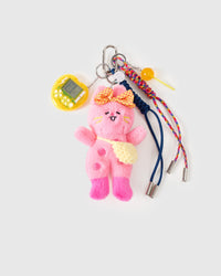 Handmade stack charm | STICKYZOO Poppy Stack Charm flat lay featuring pink plush bunny with polka-dot bow and yellow knit crossbody bag, yellow mini arcade game, glossy candy lollipop, and navy and rainbow hand-braided paracord ropes with stainless steel tips