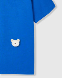 Model wearing Teddy Check-Ear T-Shirt in blue showing dropped shoulders