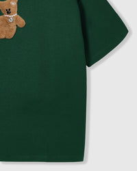 Macro view of hand-stitched bear showing embroidered face and dimensional plush construction